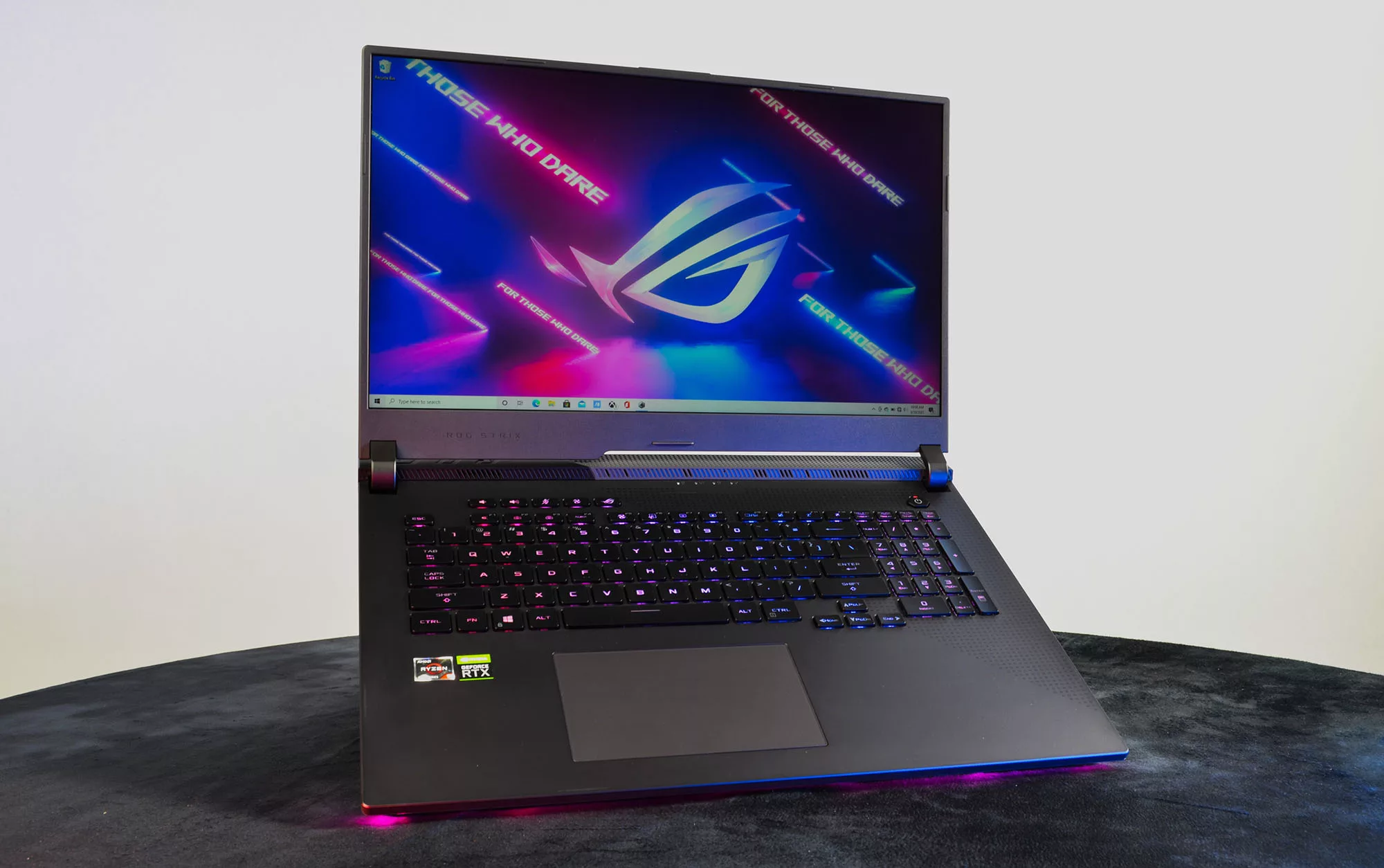 ROG Strix G17 with lid open and illuminated with purple RGB, emphasis on the screen and keyboard.