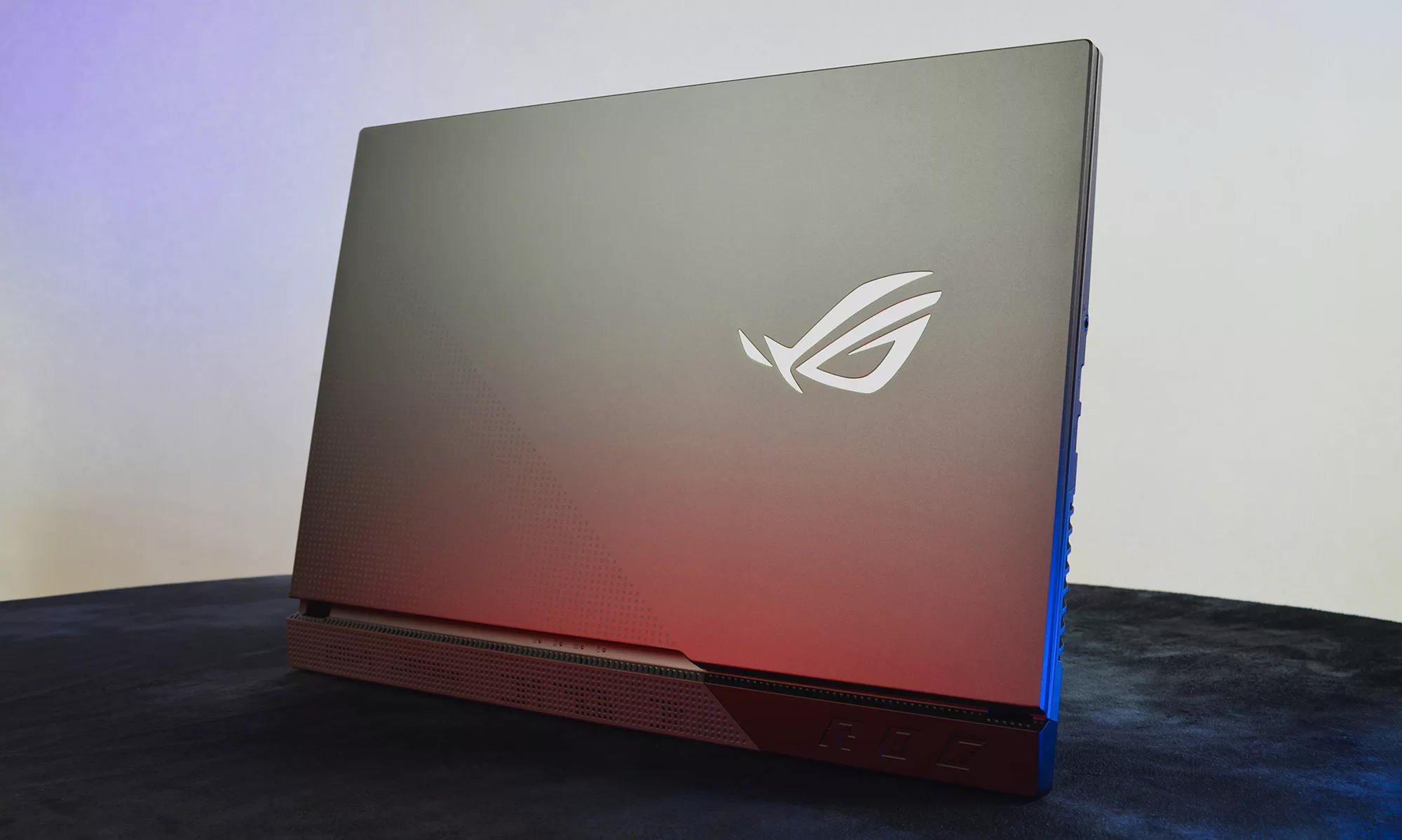 ROG Strix G17 standing on its edge, with the lid and ROG eye logo visible.