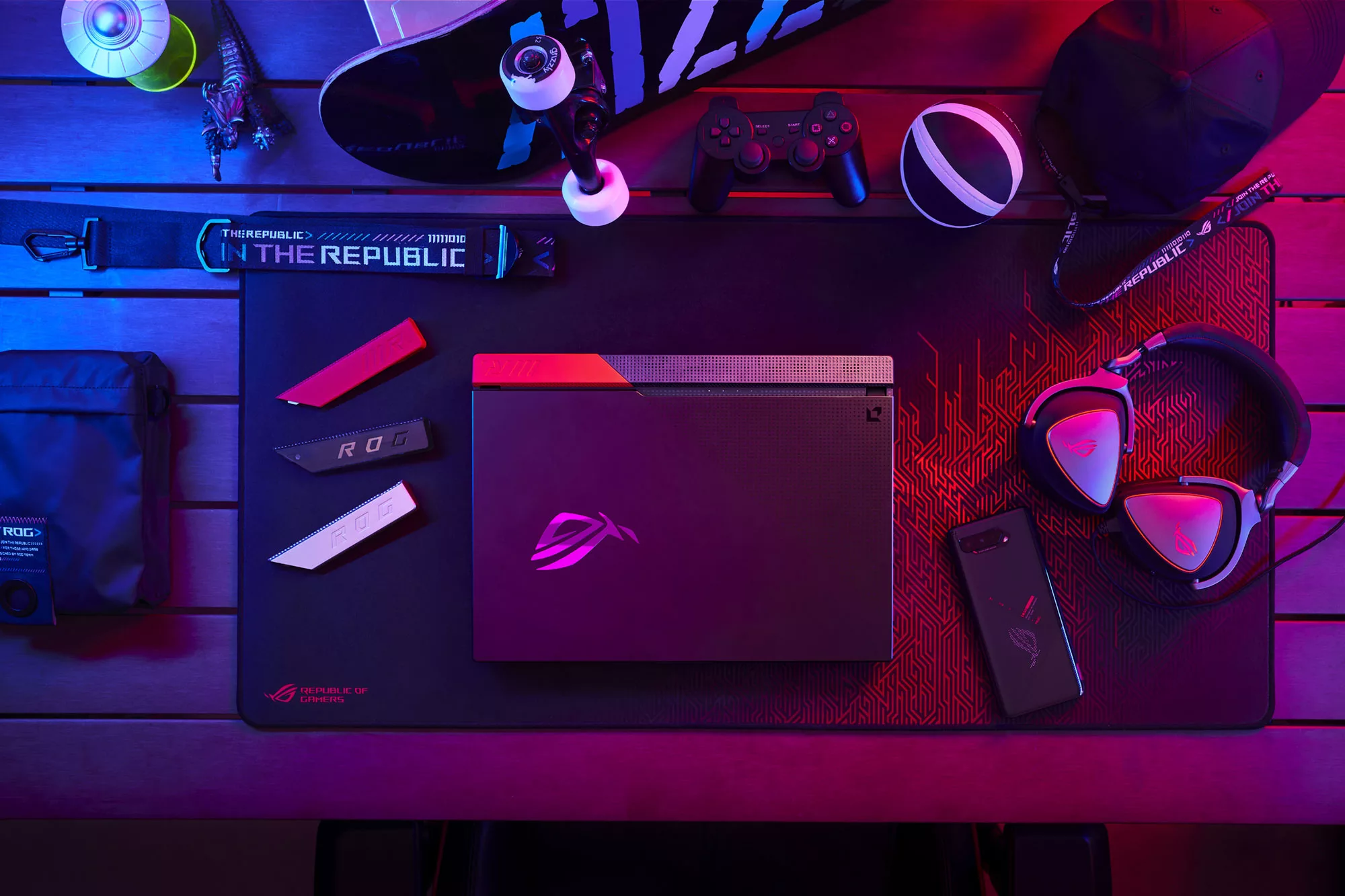 Top down view of the ROG Strix G Advantage Edition on a table, with multiple ROG peripherals nearby.