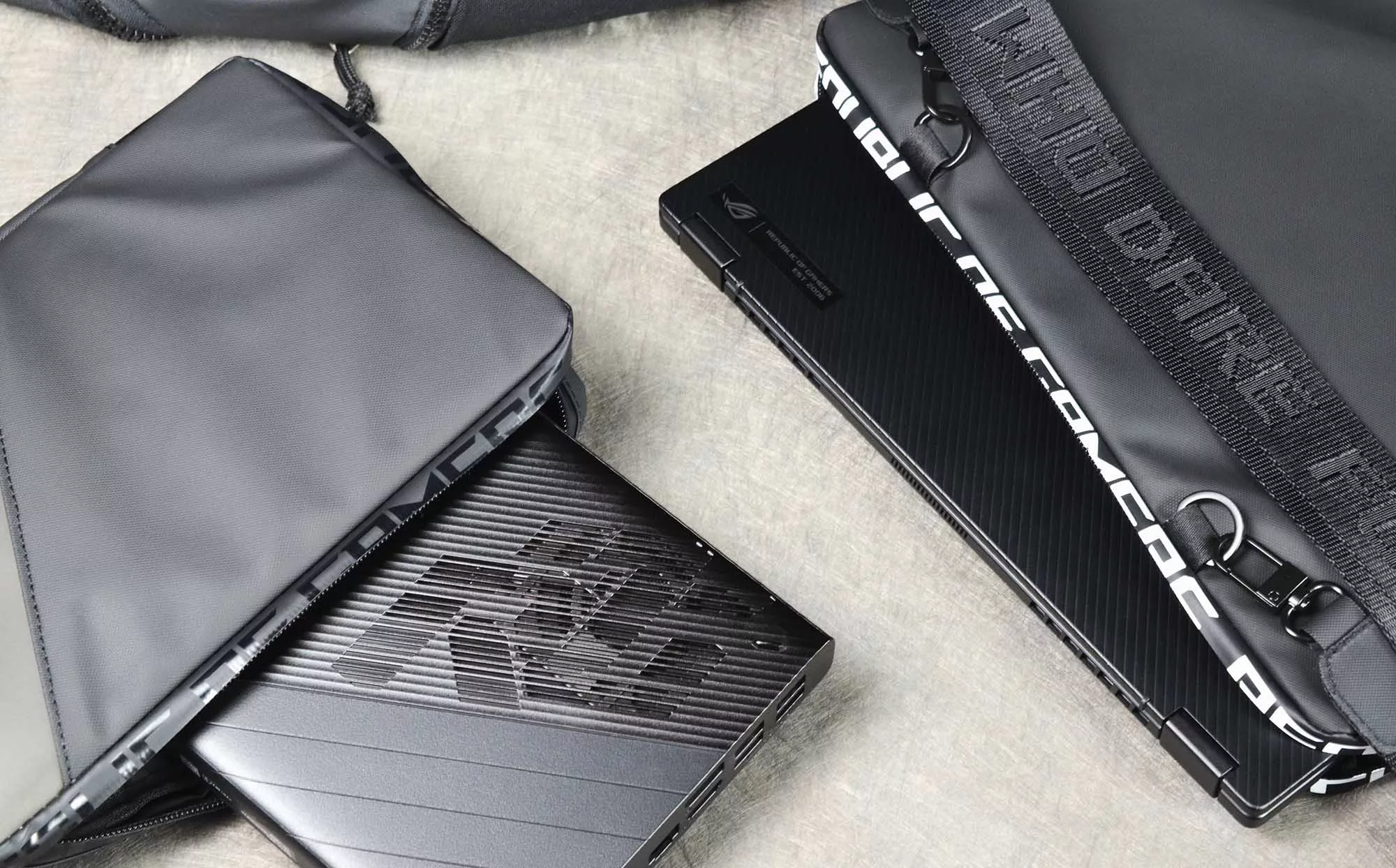 Top down view of Flow X13 and XG Mobile, both peeking out from their carrying cases.