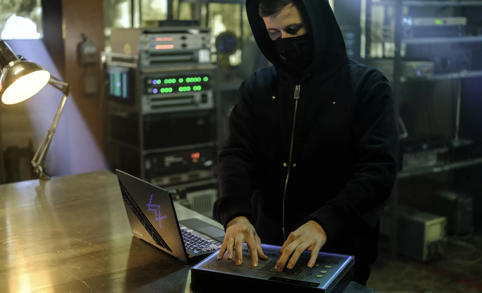 Alan Walker, standing at a table using the ROG Remix box and G14 Alan Walker Special Edition.