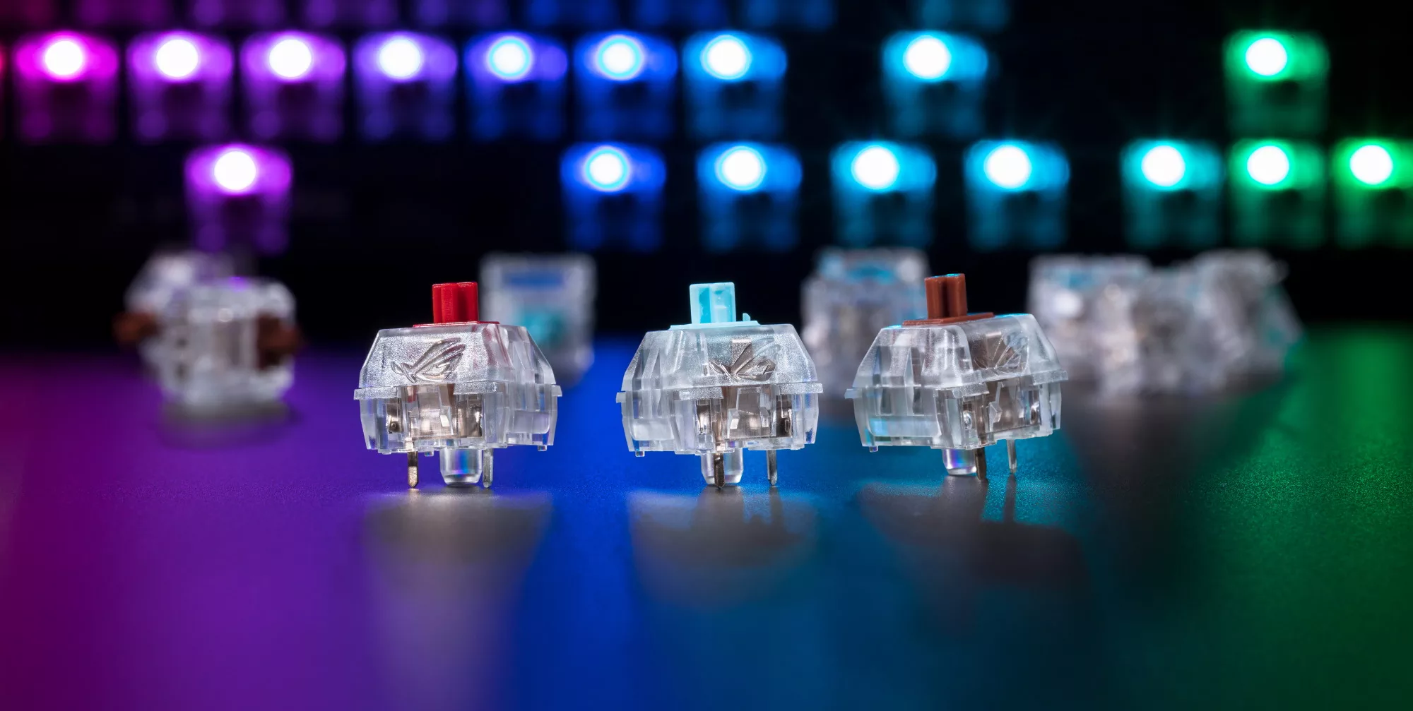 Three types of key switches on display, with RGB light diffuse in the background.