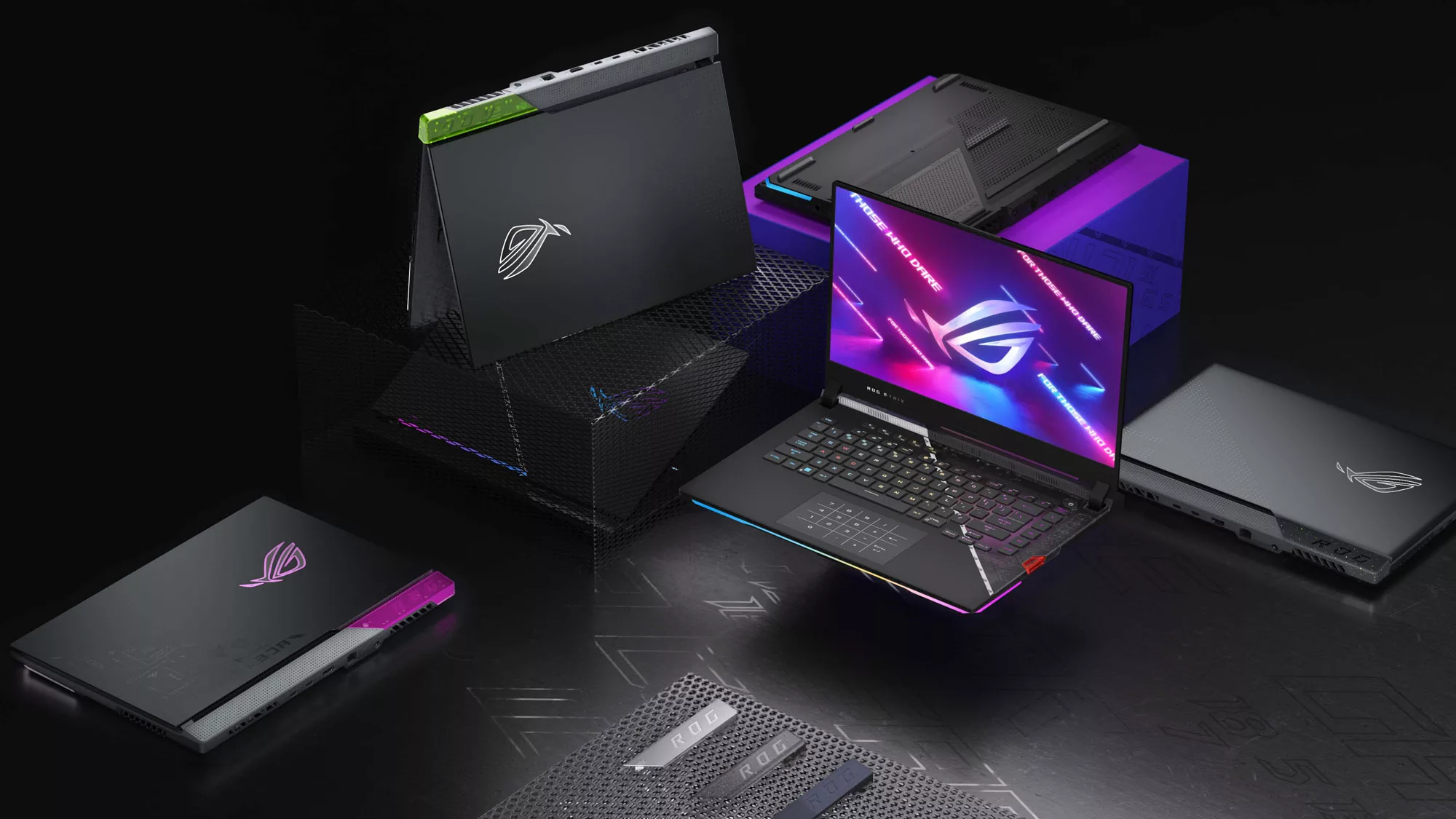 Complete Strix family photo, showing lime green and pink models, including shots of the top and bottom of the laptops.