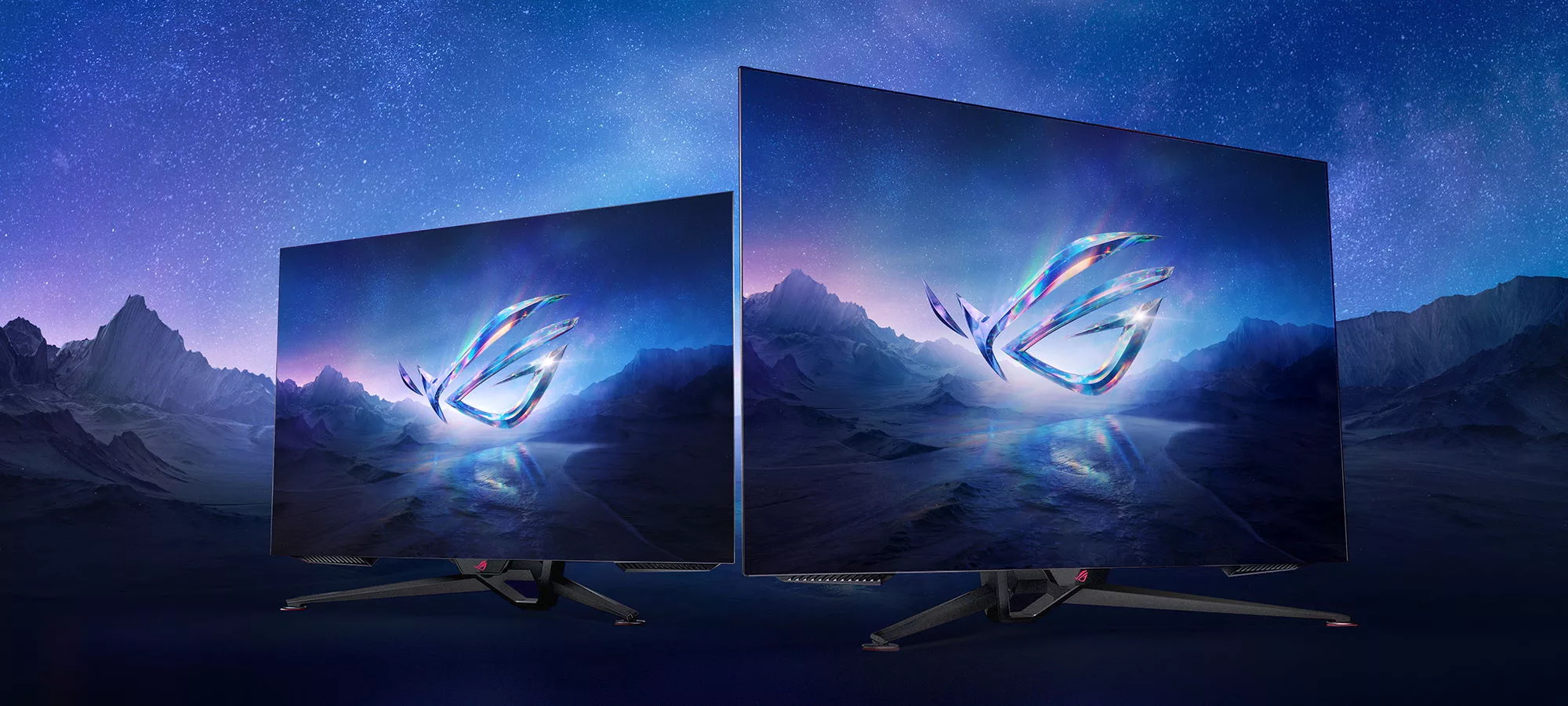 Render of two ROG monitors, featuring the ROG eye logo and with a starry night sky background.
