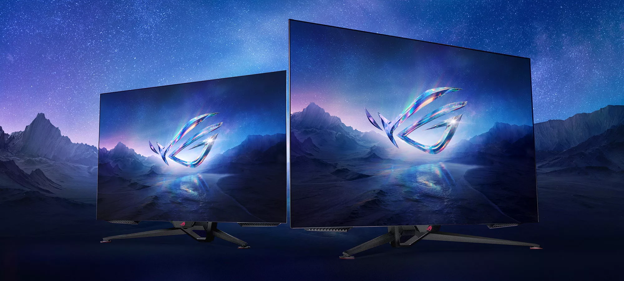 Two ROG OLED monitors with mountains and stars in the background.