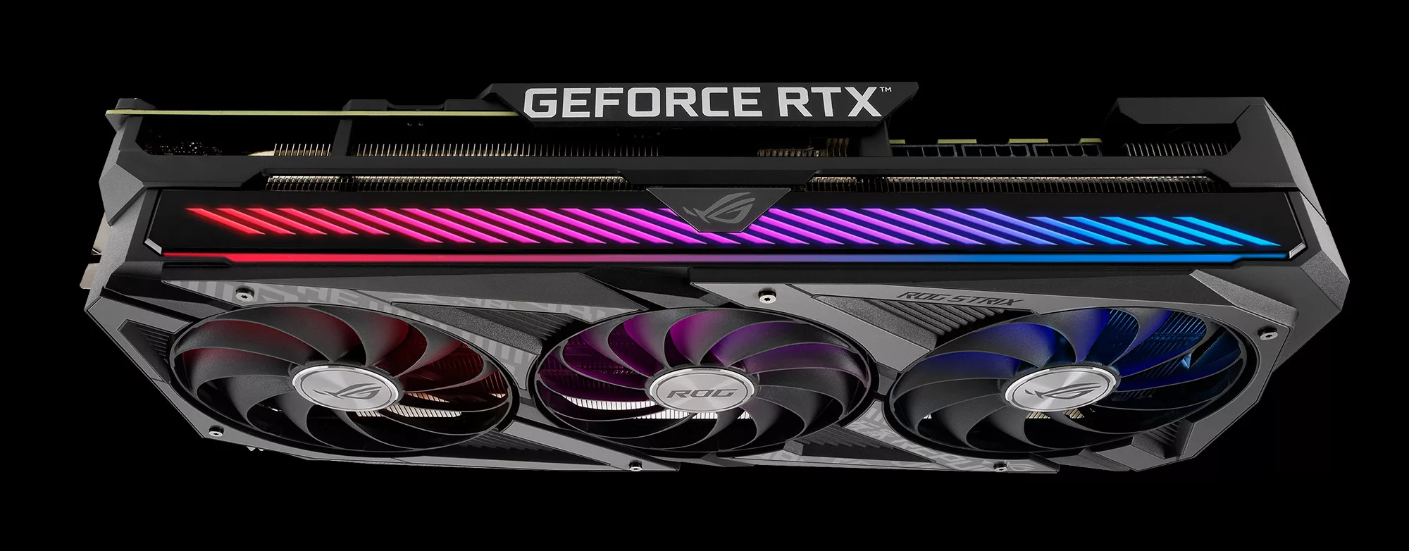 A top view of an ROG Strix RTX 3080 graphics card with colored lighting on a black background.