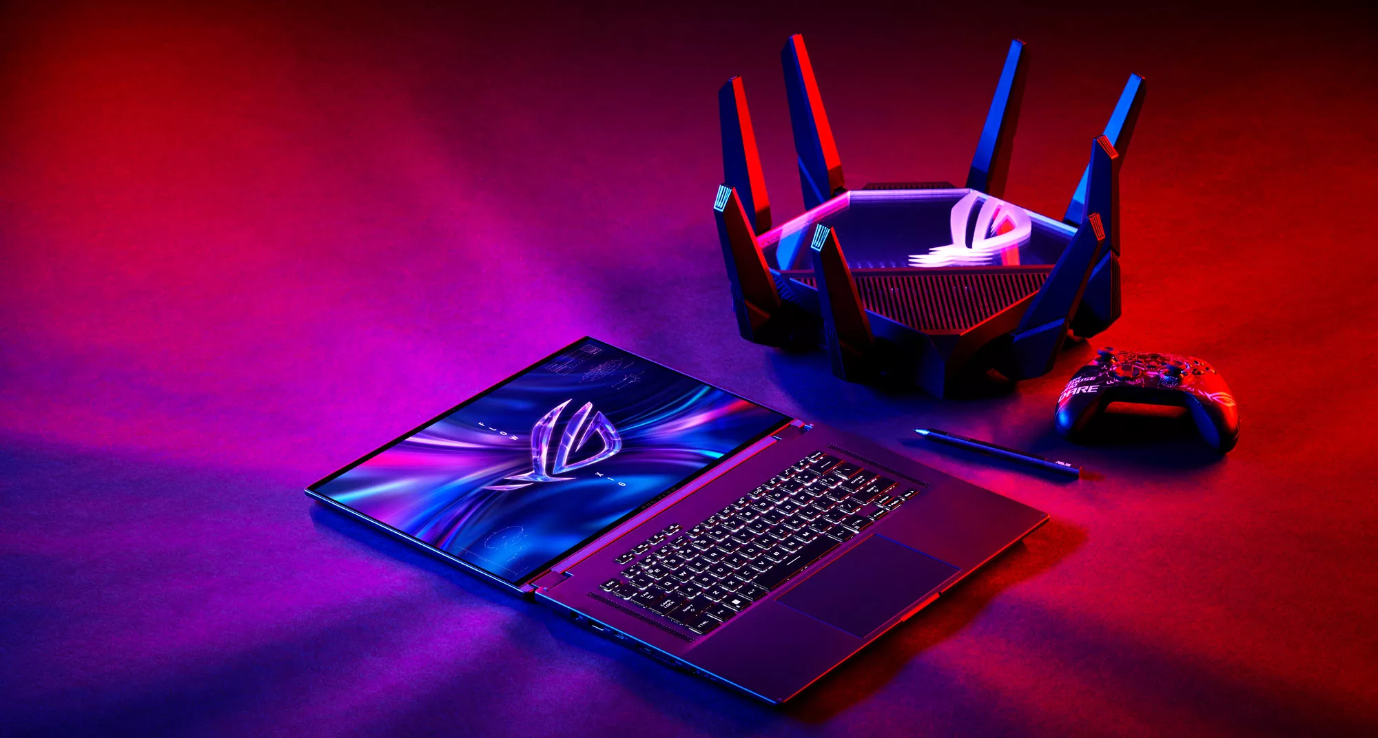 An image of the ROG Flow X16 laptop laid out on a table next to a wireless router and mouse.