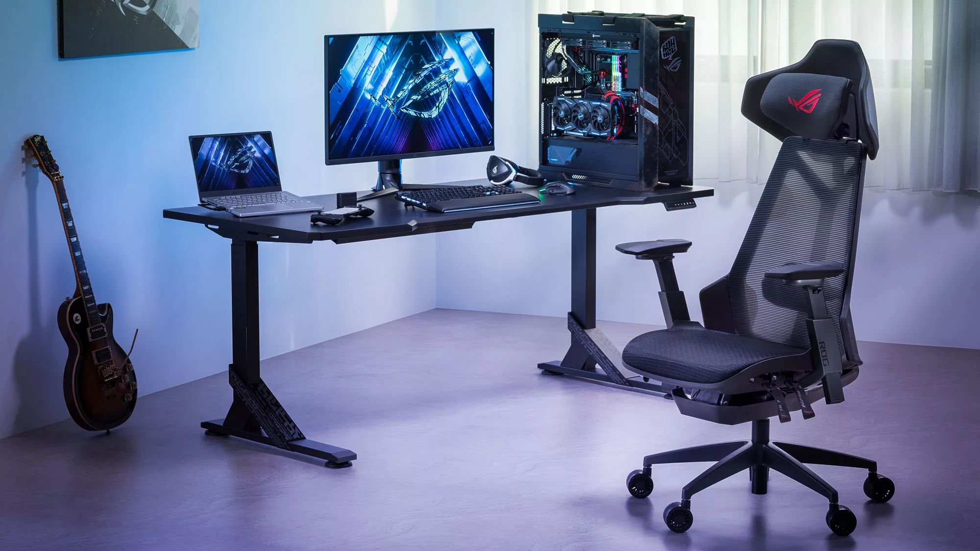 The ROG Destrier chair in a white room next to a desk with a gaming PC on top.