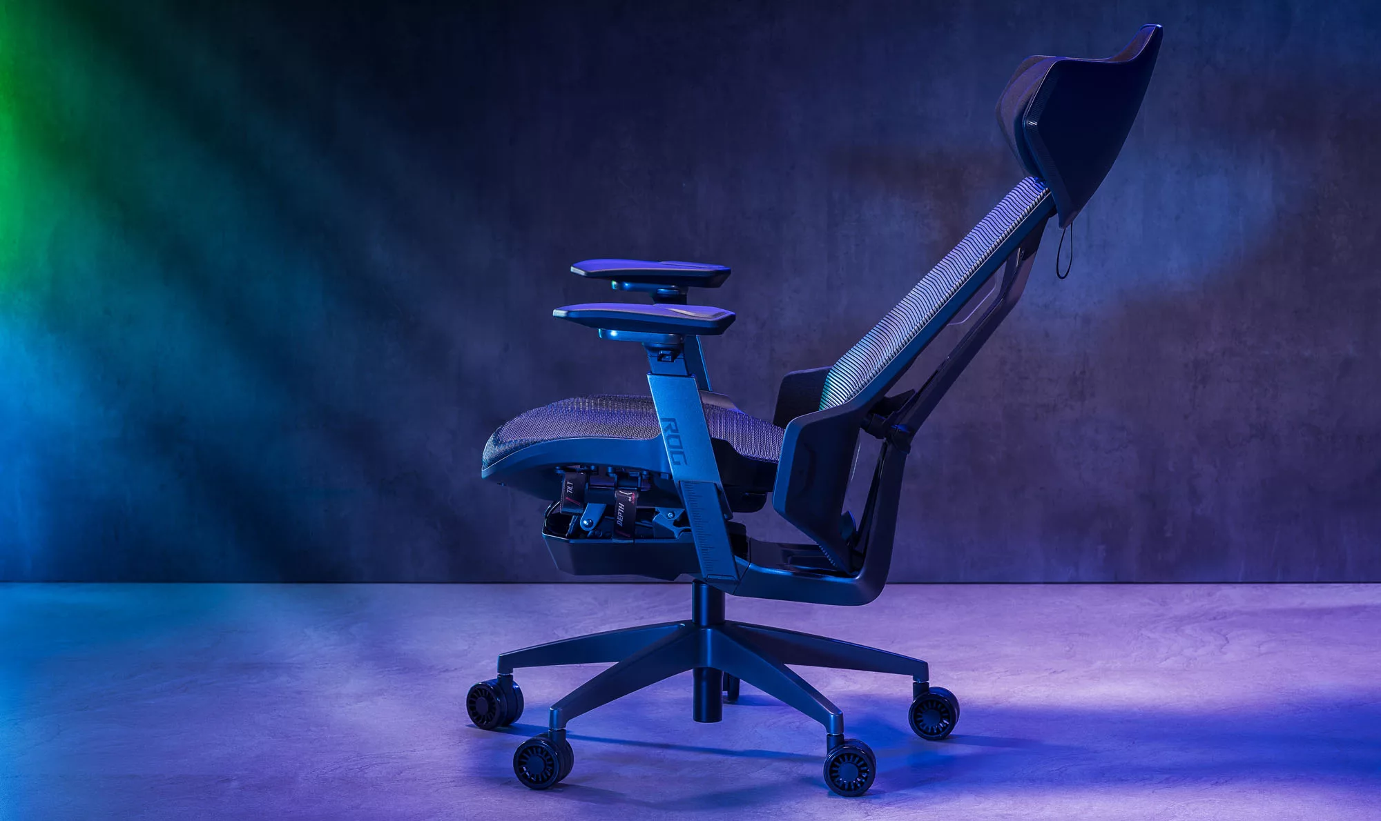 The ROG Destrier chair on a black background with the back rest reclined.