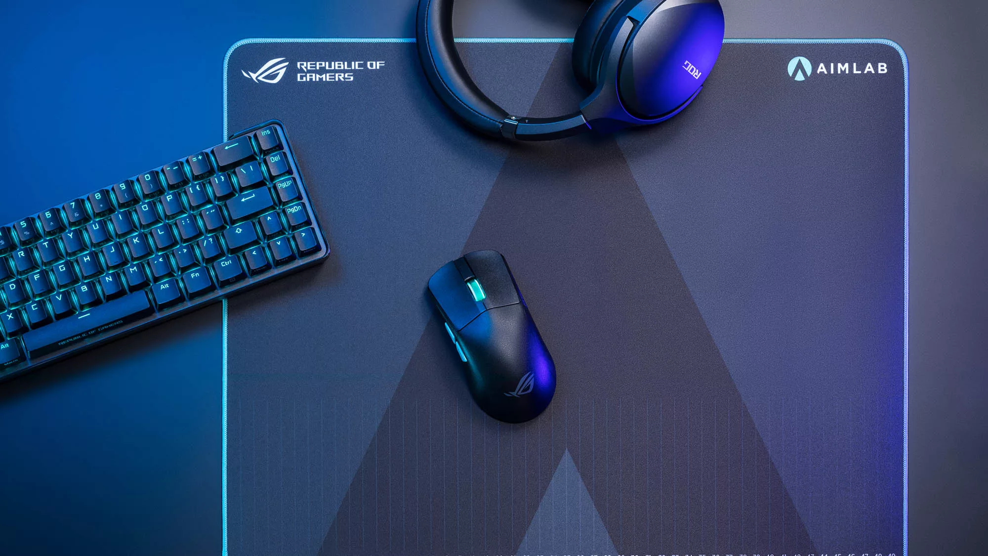 The ROG Harpe Ace mouse on a mousepad under blue lights.