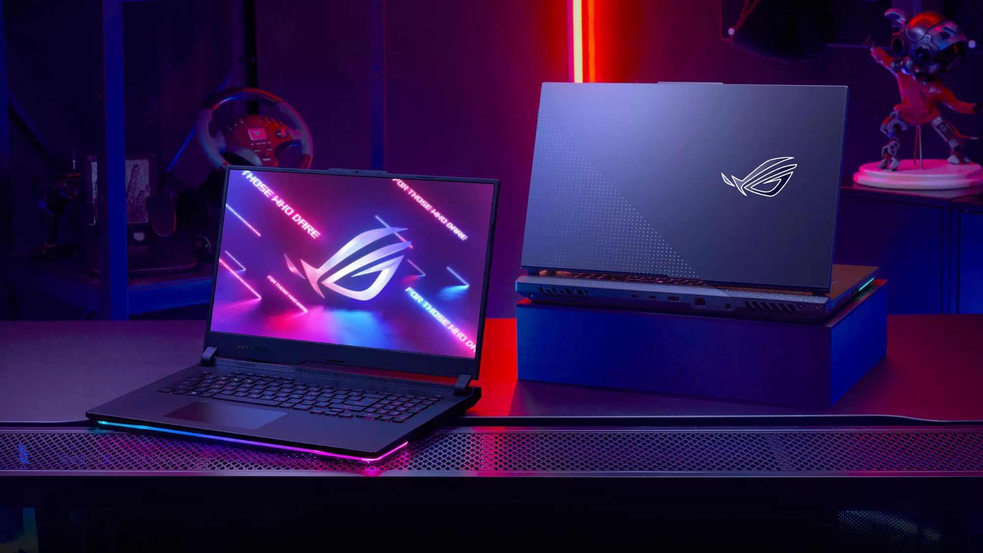 The ROG Strix SCAR 17 and Strix G17 facing opposite directions on a table.