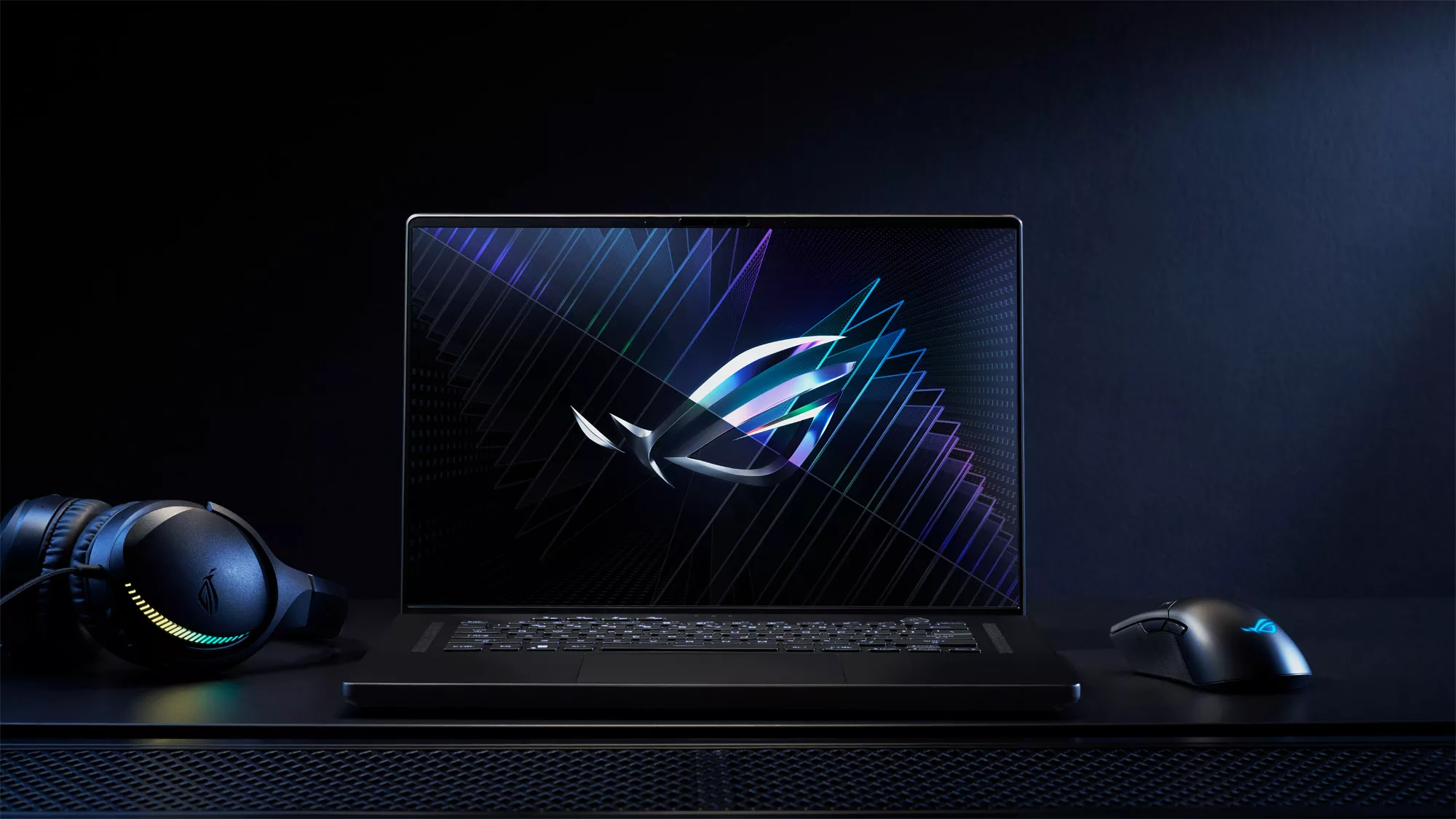 The 2023 ROG Zephyrus M16 laptop, sitting on a desk with the ROG logo on-screen.