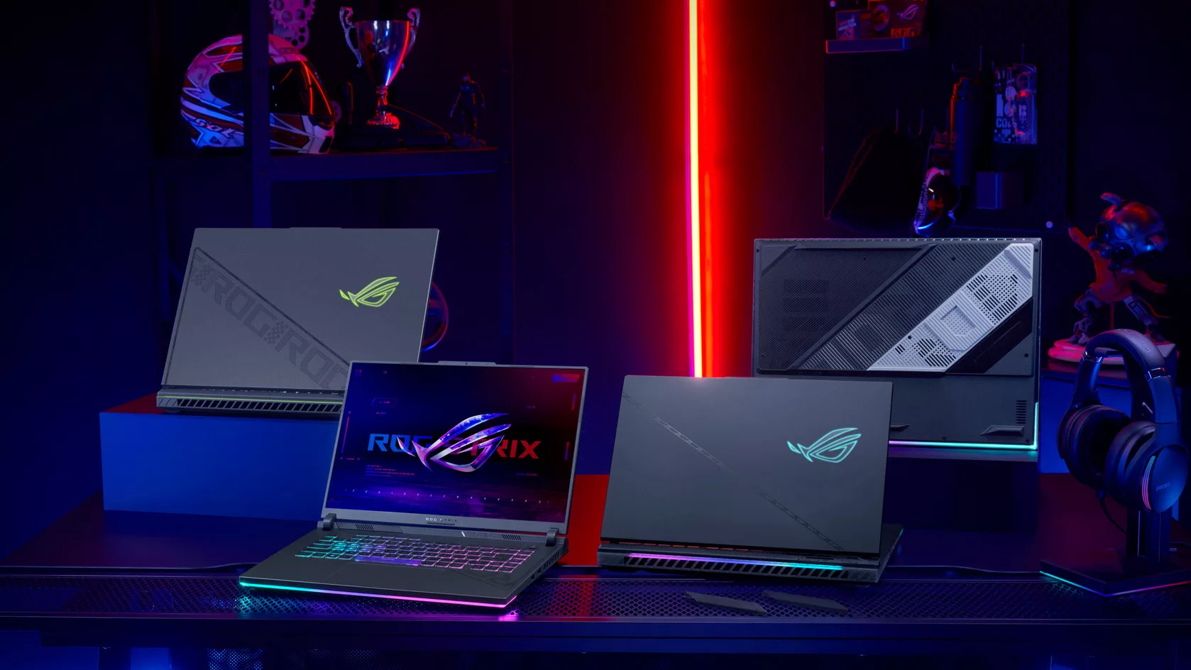 Four ROG Strix SCAR laptops on a table.